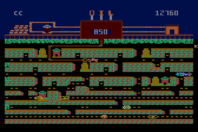Oil's Well Atari 8-bit Screenshot: The drill bit can munch on creatures, but don't let them touch the pipe!