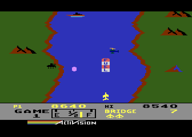 River Raid Atari 8-bit Screenshot: Enemy tanks on the shore can cause trouble.