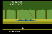 Pitfall! for Atari 2600 - Use the vines to swing over dangers.