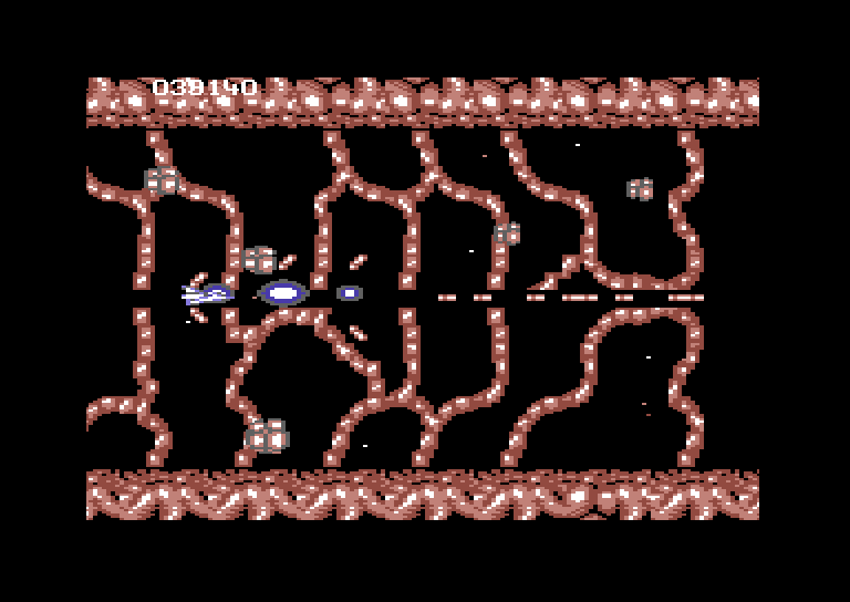 Life Force Commodore 64 Screenshot: Shooting my through a barrier.