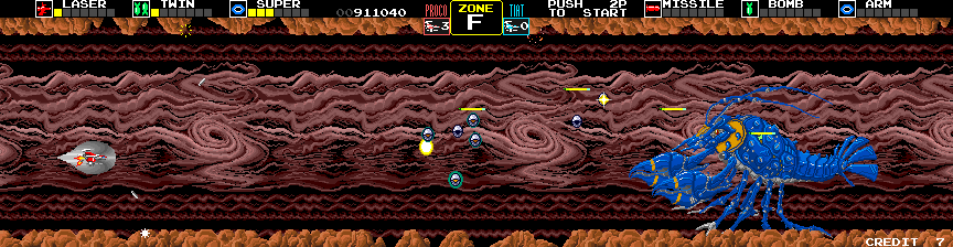 Darius Arcade Screenshot: Duel Shears in Zone F; end of level bosses change color depending on which cave they appear in.