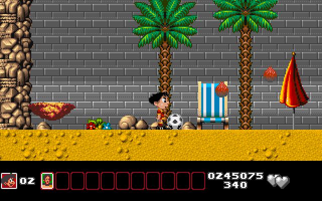 Soccer Kid IBM PC/Compatibles Screenshot: Coconuts fall out of the trees; don't get konked on the head!