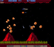 Gradius for Arcade - Near the end of the level these two volcanoes launch rocks at you...
