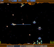 Gradius for Arcade - That structure on the ground releases new enemies until you destroy it.