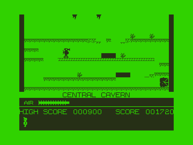 Manic Miner Dragon 32/64 Screenshot: Level completed! The screen changes to green while a bonus is awarded for leftover air.