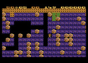 Boulder Dash for Atari 8-bit - That small patch of green slime will slowly grow into empty spaces...