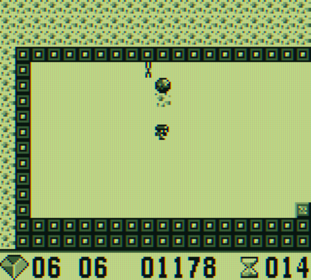Boulder Dash Game Boy Screenshot: Bonus round; crush the butterfly with the one remaining boulder.