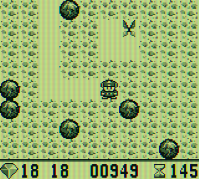 Boulder Dash Game Boy Screenshot: Crush the butterflies with rocks to form diamonds.