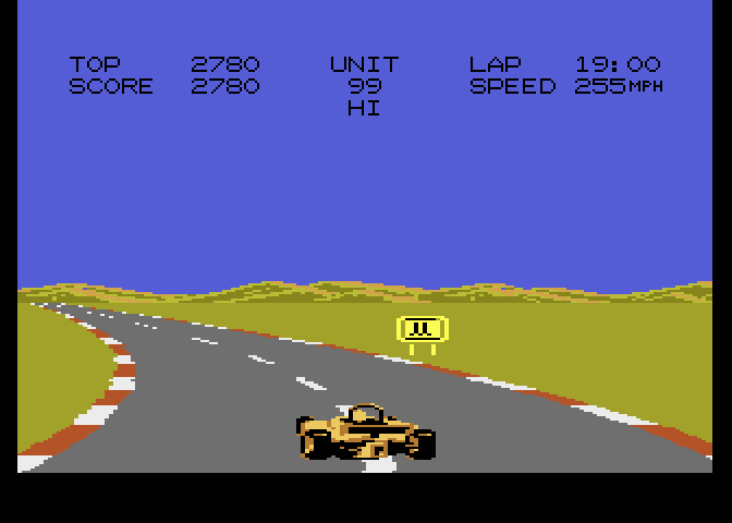 Pole Position II Atari 7800 Screenshot: Sharp turn, don't hit that sign on the side of the road...