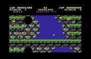 Contra for Commodore 64 - Avoid the boulders that fall out of those holes.