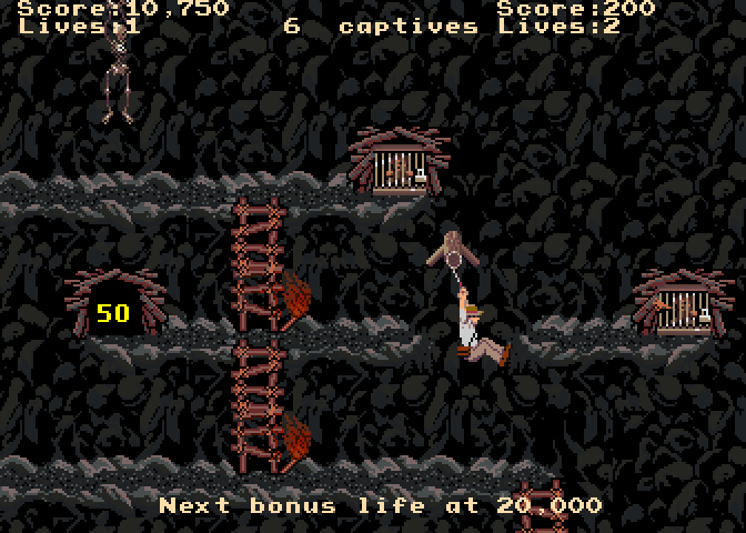 Indiana Jones and the Temple of Doom Arcade Screenshot: Using the whip to cross a gap in the platform...