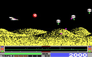 Revenge of Defender for IBM PC/Compatibles - The red "t" is a power up, be sure to collect it!